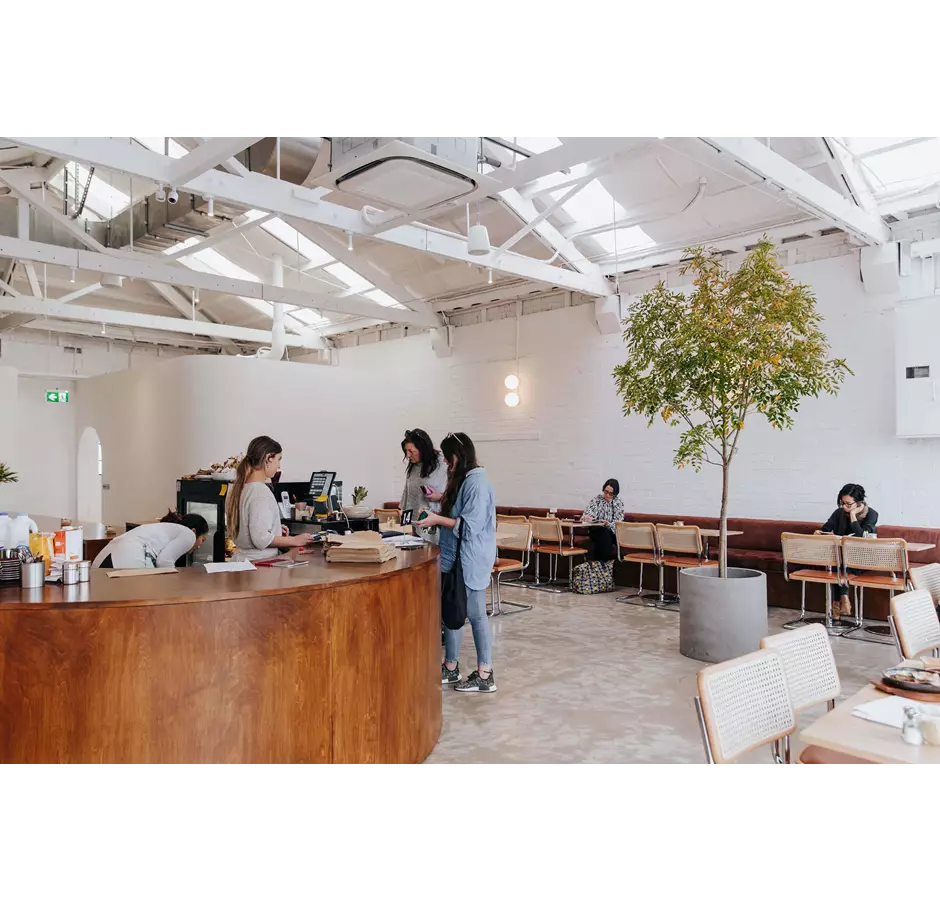People paying for their meal at the bar of Child Sister cafe.
