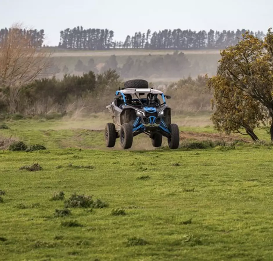 Dirt Bandits blue buggy in field.