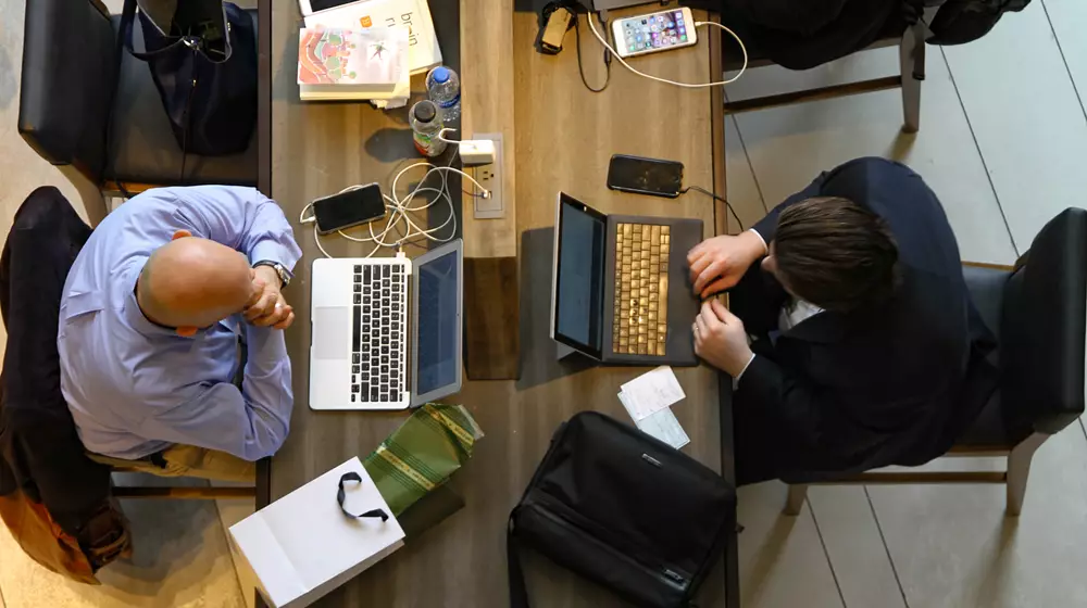 Business Businessmen Working on Laptops from above Credit Scott Winterroth