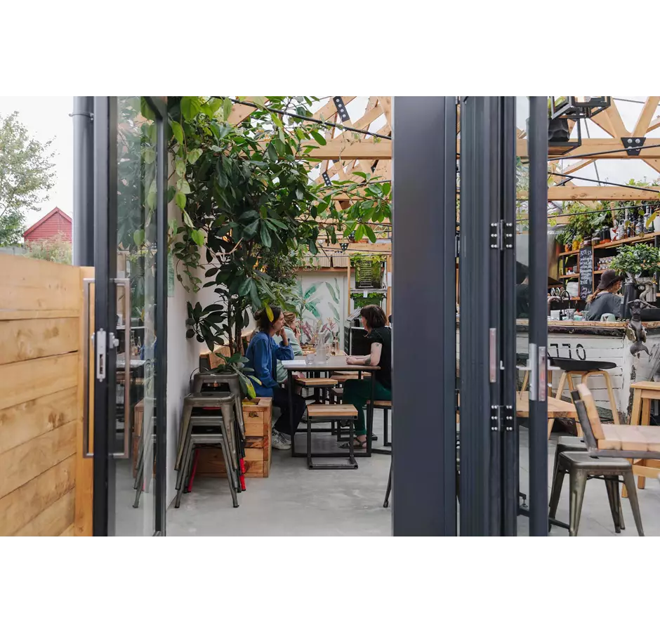 People enjoying food and drinks in the outdoor courtyard at Arbour.
