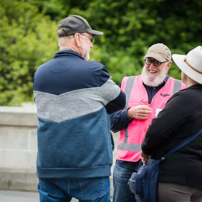 City Champion Max Lucas, a volunteer cruise ambassador for the city, sharing a joke with cruise passengers on the Bridge of Remembrance.