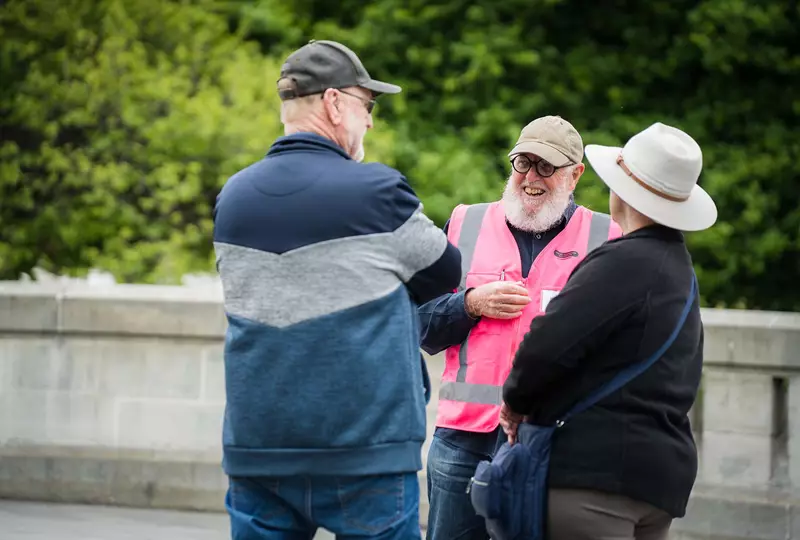 City Champion Max Lucas, a volunteer cruise ambassador for the city, sharing a joke with cruise passengers on the Bridge of Remembrance.