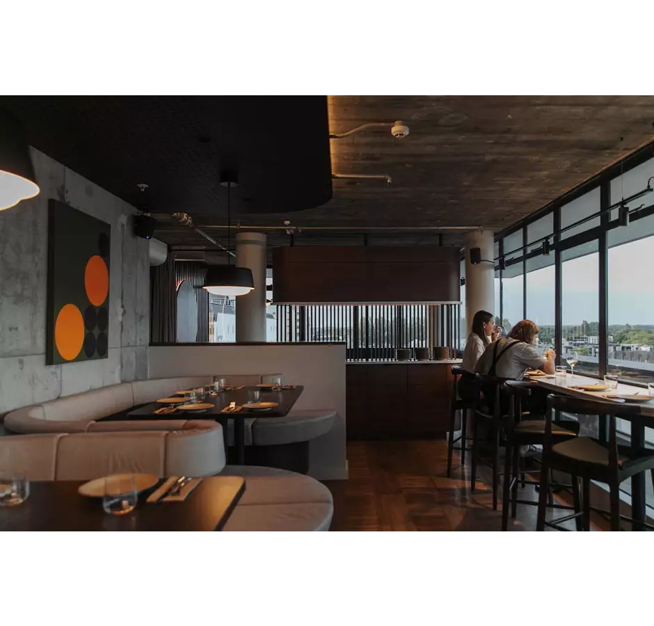 Ladies enjoying drinks with a view of the city at Seven.